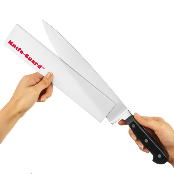 Someone removing a chef's knife from a knife guard.